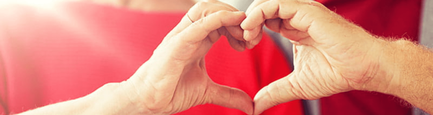 American Heart Association. Hands making a heart. Red background